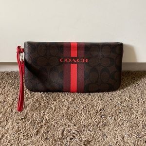 Brown and red Coach wristlet